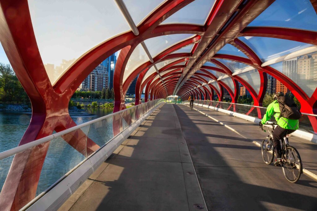 Peace Bridge across Bow River during a vibrant summer sunrise